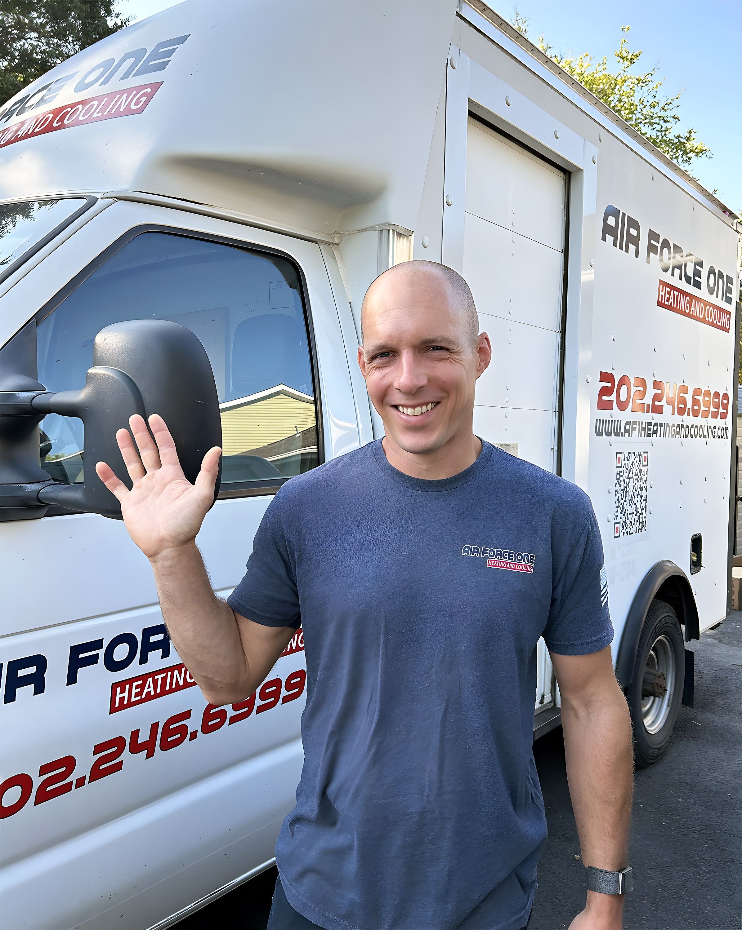 Jim Higgins, owner of Air Force One Heating & Cooling, beside a company van