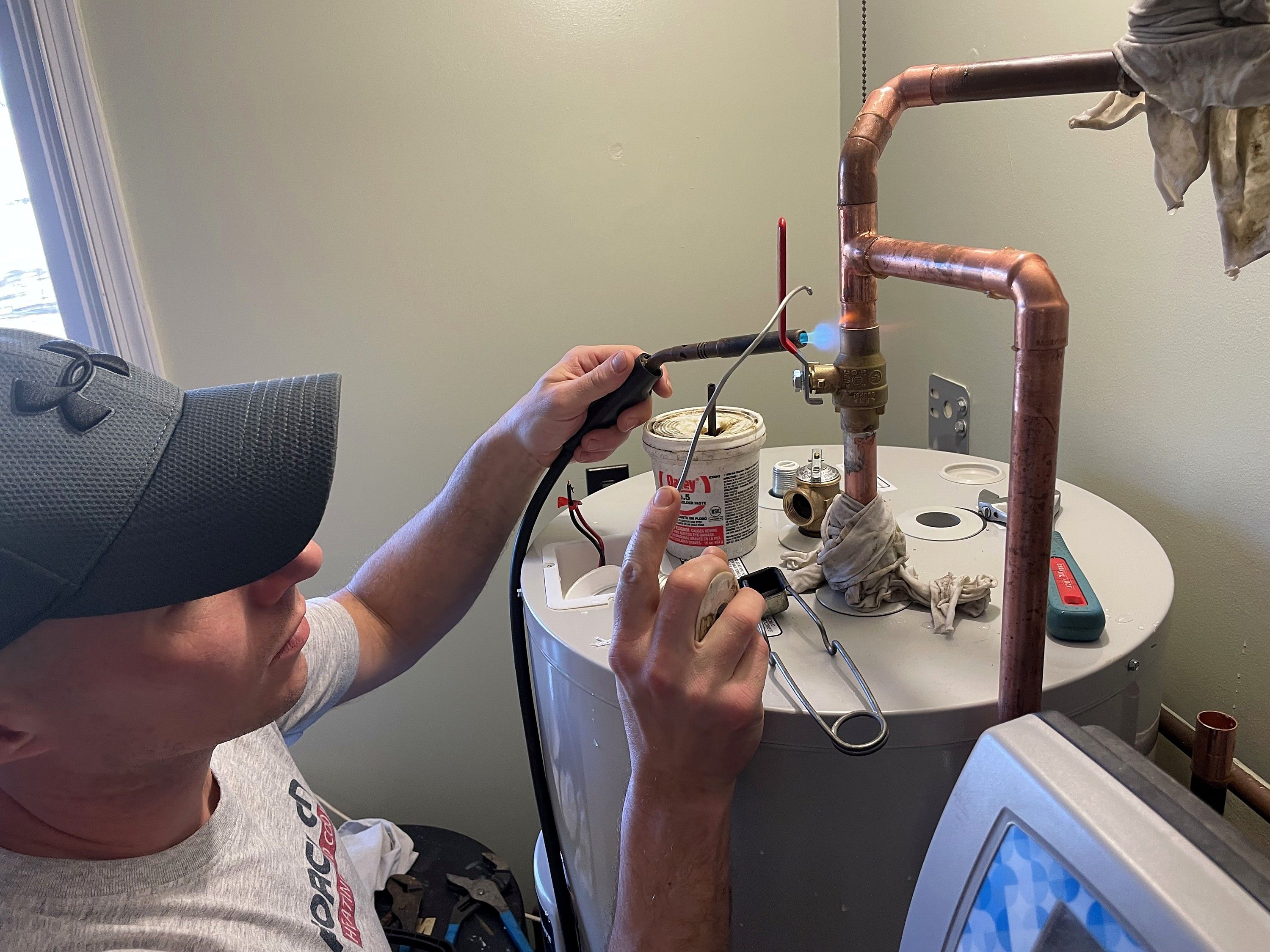 Air Force One technician servicing a residential water heater